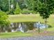 Picturesque community pond featuring lush greenery, tranquil water, and wildlife at 20056 Windalier Way, Roswell, GA 30076