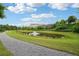 Scenic pond with a fountain surrounded by green grass and a walking trail at 20056 Windalier Way, Roswell, GA 30076