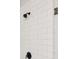Close-up of walk-in shower featuring white subway tile and black fixtures at 20056 Windalier Way, Roswell, GA 30076