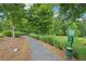 Scenic walking trail with lush greenery and a pet waste station, perfect for outdoor enjoyment at 20056 Windalier Way, Roswell, GA 30076