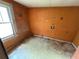 Bedroom with orange walls, damaged floors, and window at 3700 Moore Rd, Austell, GA 30106