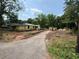 Exterior view of a yellow house with a detached shed and a driveway at 3700 Moore Rd, Austell, GA 30106