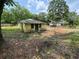 Exterior view of the house with overgrown yard at 3700 Moore Rd, Austell, GA 30106