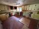 Interior view of a kitchen with sink, countertop, window, and dated cabinets at 3700 Moore Rd, Austell, GA 30106