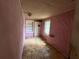 Small room with pale pink walls, window and built in shelves, in need of repair and restoration at 3700 Moore Rd, Austell, GA 30106