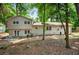 View of the backyard with patio and seating area surrounded by mature trees at 5341 Tall Oak Dr, Marietta, GA 30068