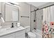 Bathroom featuring a tub-shower combo with marble tile and white vanity at 5341 Tall Oak Dr, Marietta, GA 30068