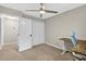 This bedroom features a ceiling fan, large window and a workspace setup at 5341 Tall Oak Dr, Marietta, GA 30068