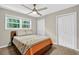 This bedroom features a ceiling fan, large window and a closet at 5341 Tall Oak Dr, Marietta, GA 30068