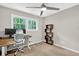 This bedroom features a ceiling fan, large window and a home office setup at 5341 Tall Oak Dr, Marietta, GA 30068