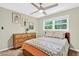 Bedroom boasts a ceiling fan, a large window, and a wood dresser at 5341 Tall Oak Dr, Marietta, GA 30068