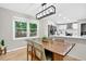 Inviting dining area with large windows overlooking the backyard and a wooden table at 5341 Tall Oak Dr, Marietta, GA 30068