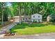 Charming two-story home with a well-manicured front yard and inviting front porch in a beautiful, wooded setting at 5341 Tall Oak Dr, Marietta, GA 30068
