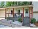 Inviting front porch with cozy seating and a decorative wreath adds charm to this home's curb appeal at 5341 Tall Oak Dr, Marietta, GA 30068