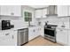 Updated kitchen boasts stainless appliances, white cabinets, and modern fixtures at 5341 Tall Oak Dr, Marietta, GA 30068