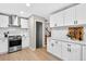 Bright kitchen with stainless steel appliances, white cabinets, and light wood floors at 5341 Tall Oak Dr, Marietta, GA 30068