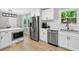 Modern kitchen with stainless steel appliances and white cabinets, blending style and functionality for a culinary haven at 5341 Tall Oak Dr, Marietta, GA 30068