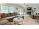 Inviting living room featuring a comfortable sectional, stone fireplace, and bright windows at 5341 Tall Oak Dr, Marietta, GA 30068