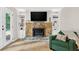 Cozy living room featuring a stone fireplace, built-in shelves, and natural light at 5341 Tall Oak Dr, Marietta, GA 30068