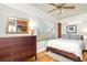 Bright bedroom featuring wood floors, a ceiling fan, and a wooden dresser and bed frame at 608 Hardendorf Ne Ave, Atlanta, GA 30307
