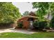 Charming brick home featuring a well-manicured lawn and mature trees at 608 Hardendorf Ne Ave, Atlanta, GA 30307