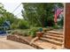 Charming front yard view with stone steps, greenery, and glimpses of neighborhood homes at 608 Hardendorf Ne Ave, Atlanta, GA 30307