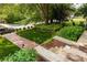 Landscaped front yard featuring a brick pathway, lush lawn, and well-maintained greenery at 608 Hardendorf Ne Ave, Atlanta, GA 30307
