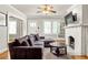 Cozy living room with hardwood floors, fireplace, and large comfortable couch at 608 Hardendorf Ne Ave, Atlanta, GA 30307