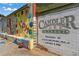 Exterior wall features a colorful mural and signage for Candler Park Market with text listing offered provisions at 608 Hardendorf Ne Ave, Atlanta, GA 30307