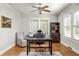 Home office featuring a desk, arm chair, and bookshelves with natural light from large windows at 608 Hardendorf Ne Ave, Atlanta, GA 30307