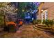 Inviting back patio features stone flooring, cozy seating, string lights, and access to the home's entrance at 907 Eden Se Ave, Atlanta, GA 30316