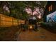 Backyard with outdoor movie screen, fire pit, wood fence, and gravel ground covering, perfect for entertaining at 907 Eden Se Ave, Atlanta, GA 30316