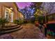 Backyard stone patio featuring lighting and seating near lush landscaping at 907 Eden Se Ave, Atlanta, GA 30316