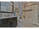 Bathroom with black and white tile, dark cabinets and marble countertop at 907 Eden Se Ave, Atlanta, GA 30316