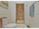 Bathroom featuring walk-in shower with tiled walls and bench, and traditional wainscotting at 907 Eden Se Ave, Atlanta, GA 30316