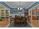 Inviting dining room with elegant lighting fixture, stylish decor, and seamless access to kitchen at 907 Eden Se Ave, Atlanta, GA 30316