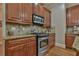 Gourmet kitchen showcasing stainless steel oven range, backsplash, granite counters, and custom wood cabinets at 907 Eden Se Ave, Atlanta, GA 30316