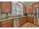 Charming kitchen featuring granite countertops, stainless steel appliances, and natural wood cabinetry at 907 Eden Se Ave, Atlanta, GA 30316