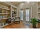 Charming living room area with custom built-in shelving, french doors and hardwood floors at 907 Eden Se Ave, Atlanta, GA 30316