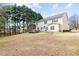 Large backyard with a two-story home, trees, and an in-ground hot tub with a patio at 2030 Brook Meadow Dr, Alpharetta, GA 30005