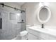 Chic bathroom boasts a glass shower and vanity with a white countertop and oval mirror at 2030 Brook Meadow Dr, Alpharetta, GA 30005