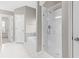 Bright bathroom with an enclosed glass shower, garden tub, and white tiled floor at 2030 Brook Meadow Dr, Alpharetta, GA 30005