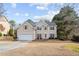 Charming two-story home featuring a two-car garage and a well-manicured front yard at 2030 Brook Meadow Dr, Alpharetta, GA 30005