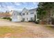 Two-story home featuring a well-manicured front yard with mature trees and attached garage at 2030 Brook Meadow Dr, Alpharetta, GA 30005