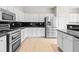 The kitchen features granite countertops, stainless appliances, and white cabinets at 2030 Brook Meadow Dr, Alpharetta, GA 30005