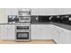 The kitchen features white cabinets and stainless steel appliances at 2030 Brook Meadow Dr, Alpharetta, GA 30005