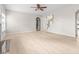 Spacious living room with light wood floors and access to other rooms at 2030 Brook Meadow Dr, Alpharetta, GA 30005