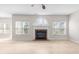 Open-concept living room featuring a fireplace, hardwood floors, and natural light at 2030 Brook Meadow Dr, Alpharetta, GA 30005