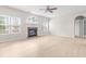 Bright living room with fireplace, lots of windows, and light wood floors at 2030 Brook Meadow Dr, Alpharetta, GA 30005