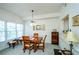 Inviting dining room features a wooden table set, large windows and neutral carpet at 211 Colonial Homes Nw Dr # 2304, Atlanta, GA 30309